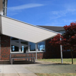 Pergola-Markise Markilux - Seitenansicht Pergola-Markise Markilux für Außensitzplatz einer Firma - Seitenansicht